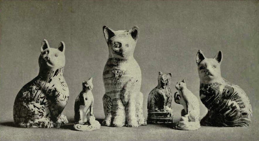 A GROUP OF CATS IN POTTERY